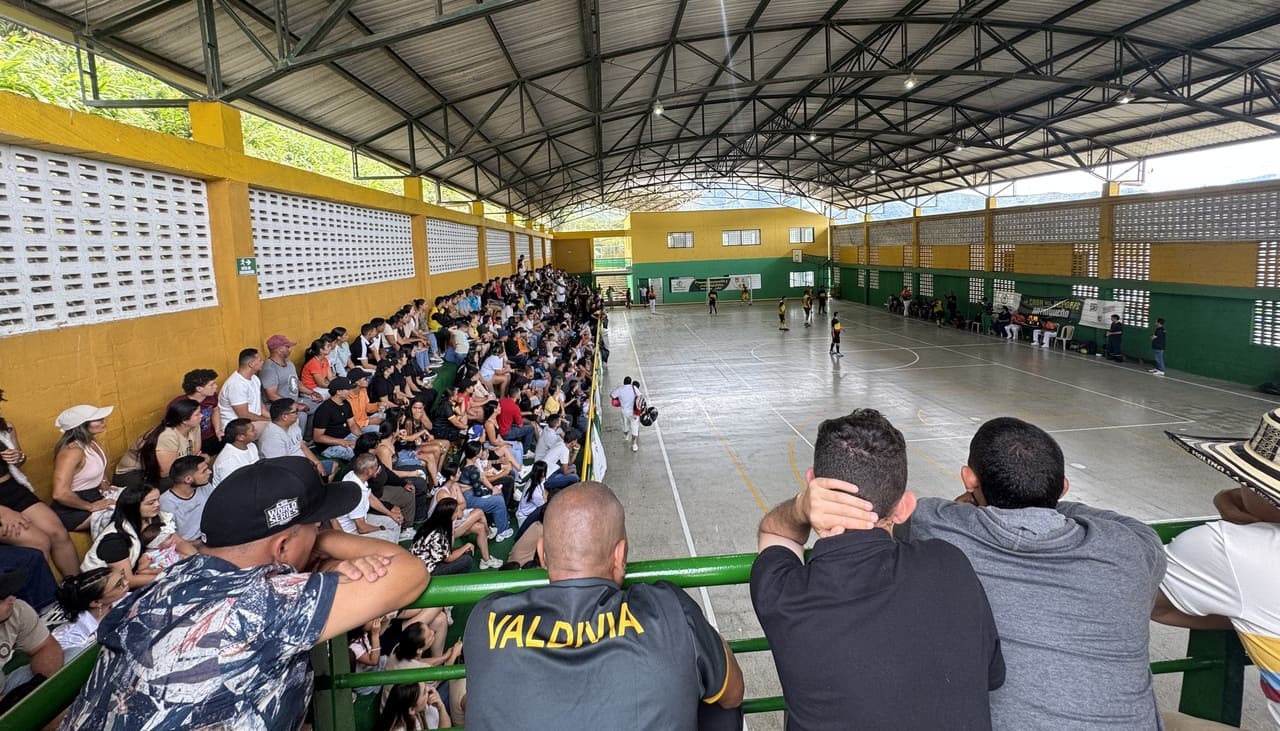 Figura 5. El coliseo municipal de Valdivia durante la final masculina de fútbol de salón. Nota: el mismo escenario que semanas antes albergó a 92 familias desplazadas por el conflicto armado se llenó de aficionados. La transición de refugio humanitario a escenario deportivo ilustra el proceso de adecuación socio-técnica descrito por Thomas (2008). Valdivia, Antioquia, septiembre de 2025. Fotografía del autor.